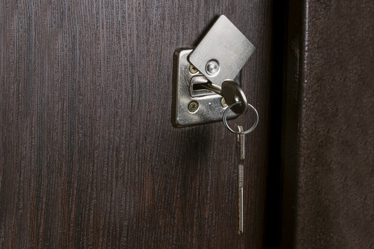 key in the entrance door, closeup image