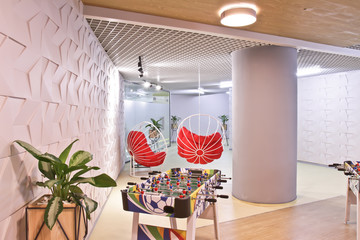 Interior of the staff rest room in the modern office of the business center. Round chair-swing for...