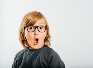 Studio shot of cute little boy wearing eyeglasses