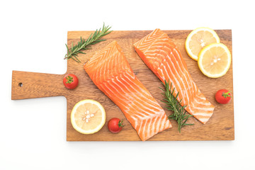 Raw salmon fillet with tomatoes lemon rosemary pepper and salt