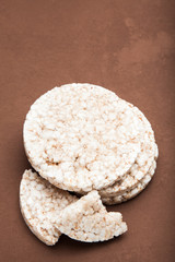 Portion of rice cookies on a brown background.