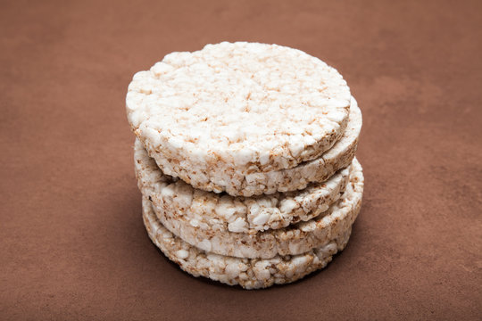 Dietary rice snack on a brown background.
