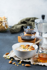 Breakfast with black coffee muesli granola honey nuts milk