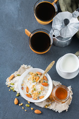 Obraz na płótnie Canvas Breakfast with black coffee muesli granola honey nuts milk