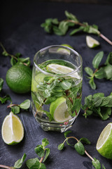 Glasse of Mojito with lime and mint. Summer refreshing cocktail on a grey metal background