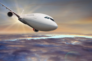 Fototapeta na wymiar Commercial airplane flying above clouds.