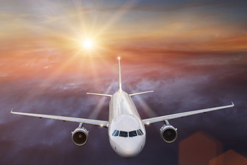 Commercial airplane flying above clouds.