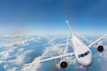 Obraz premium Commercial airplane flying above clouds.