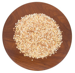 Five cereals mixed. On wooden plate, isolated on white.