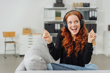 Extrovert young woman singing along to her music