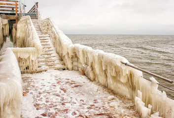 ice covered staircase on the beach