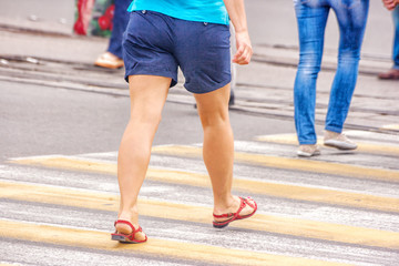 young woman feet, crossing an urban street