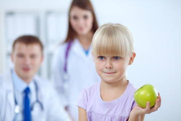 Fototapeta premium Female doctor examining child with stethoscope at surgery