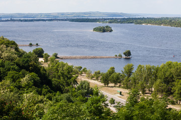 Fototapeta na wymiar Panoramic view from mountain Tarasova in Kanev, Cherkassy region, on small island and hydroelectric dam on broad Dnieper