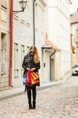 Fototapeta na wymiar Cute teen checks her bags in old town