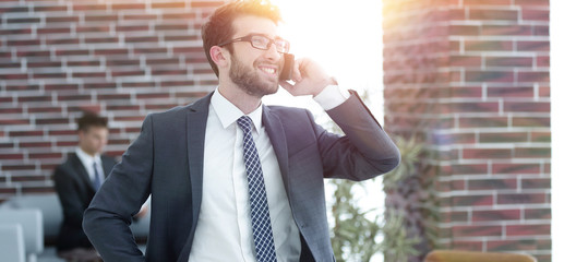 businessman talking on smartphone in his office