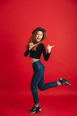 Full length portrait of a cheerful stylish girl wearing hat