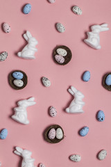 Easter background with easter eggs and easter bunnies on a pink background