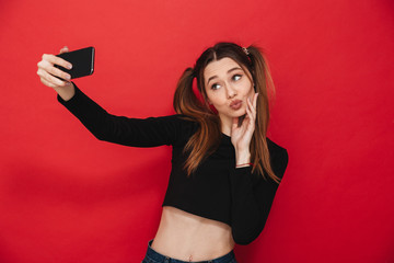 Naklejka premium Young cute woman make selfie by mobile phone