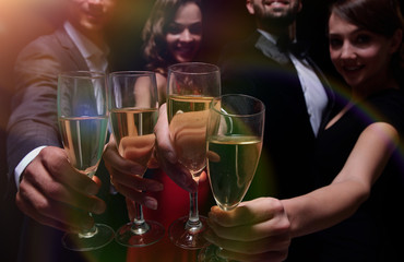 Cheerful people celebrating a sucess with Champagne