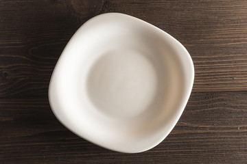 White plate on a dark wooden background