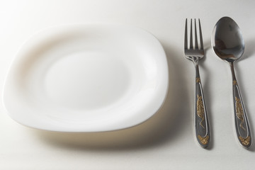  Fork, spoon and white plate on white background