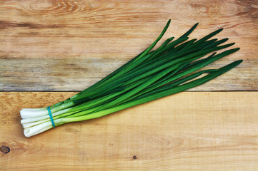 Green onion on wooden background