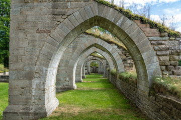 Fototapeta na wymiar Corridor of arches from a ruin of a medieval cloister