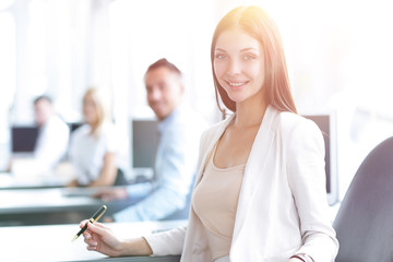 portrait of a female assistant sitting at a Desk