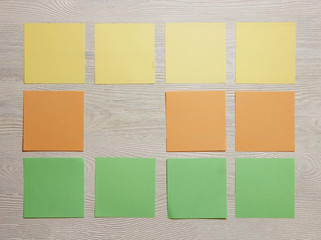 Stationary, Blank Colored Sticker Notes on White Wooden Board. Top View. Flat Lay. Time-management, Planning.