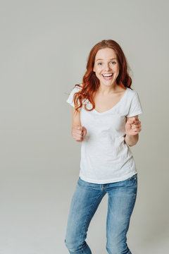 Motivated happy young redhead woman