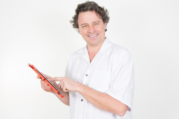 Smiling doctor working with a tablet computer in his office