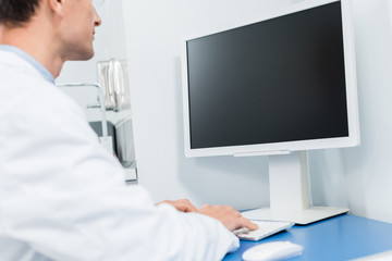 Fototapeta premium Doctor working by computer in modern clinic