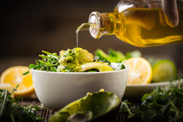 pouring olive oil to lettuce