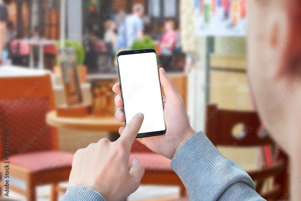 Poster Man use mobile phone with isolated screen for mockup in coffee shop. Modern smart phone with round edges.