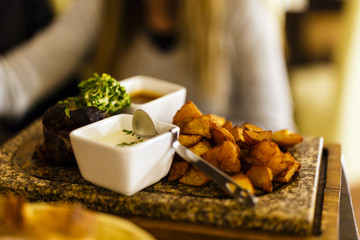 stone beef with sauce and fried potatoes with selective focus