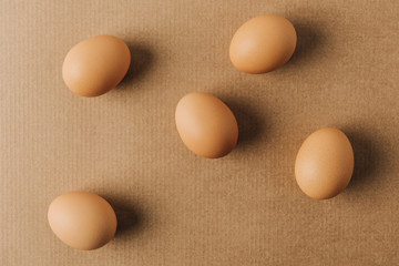 brown eggs scattered on brown carton