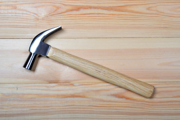 Iron hammer on wooden.