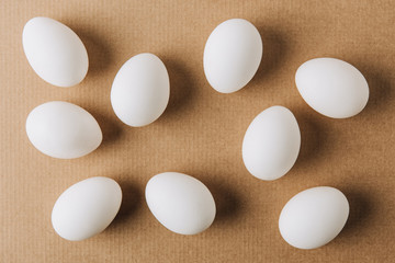 white eggs scattered on brown carton