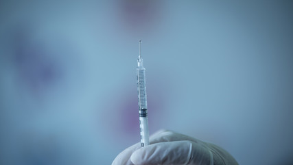 A Doctor prepared syringe of vaccine to injunction patient