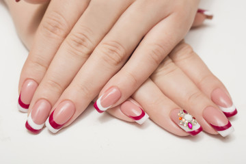 Obraz na płótnie Canvas Manicure. White nails with red hearts. Isolated.
