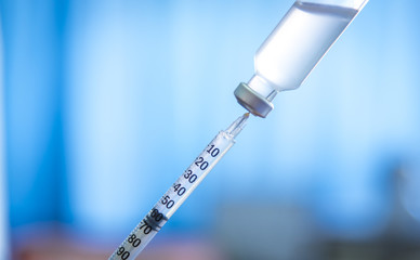 A Doctor prepared syringe of vaccine to injunction patient