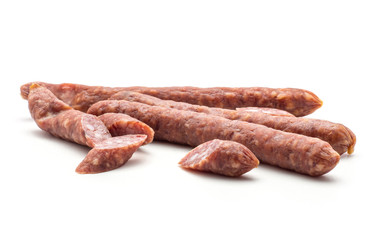 Three Hungarian dry sausages pepperoni with cut pieces isolated on white background smoked in natural casing mixed pork and beef.