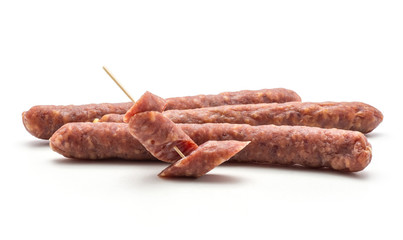Three Hungarian dry sausages pepperoni and two pieces isolated on white background smoked in natural casing mixed pork and beef.