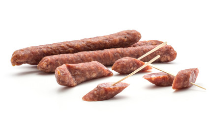 Hungarian dry sausages pepperoni isolated on white background smoked in natural casing mixed pork and beef whole and cut in pieces like canape.