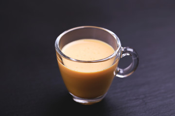 Indian turmeric milk with saffron, cardamom and turmeric. Copyspace