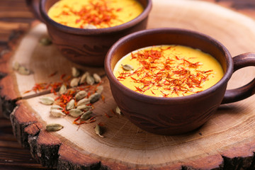 Indian turmeric milk with saffron, cardamom and turmeric. Copyspace