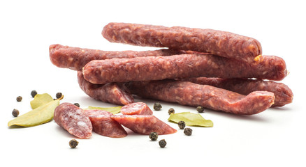 Hungarian dry sausages pepperoni set with black pepper and bay leaves isolated on white background smoked in natural casing mixed pork and beef.