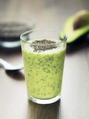 Avocado chia pudding in a glass on dark rustic background