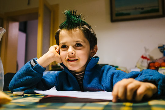 portrait of 9 year old baby boy with crest of green colored hair